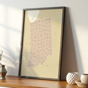 Minimalist Indiana map print with county labels displayed in a sleek black frame on a wooden shelf.