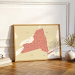 Large framed New York map leaning against a wall on wooden flooring, styled as minimalist home décor.