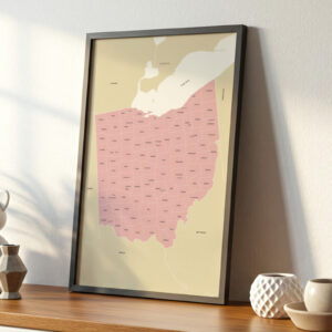 Framed Ohio map leaning on a wooden shelf, surrounded by simple ceramic décor and illuminated by gentle morning light.