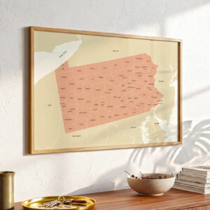Framed Pennsylvania map artwork mounted above a wooden shelf, accented by decorative objects and light shadows cast across the wall.