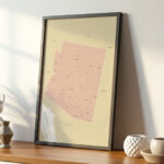 Close-up view of a framed Printable Arizona Map displayed on a wooden surface with ceramic décor.
