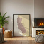 California map wall art positioned on the floor next to a glowing fireplace, adding a warm accent to a relaxed living room setting.