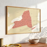 Framed New York county map hanging on a textured wall, styled with warm natural lighting.