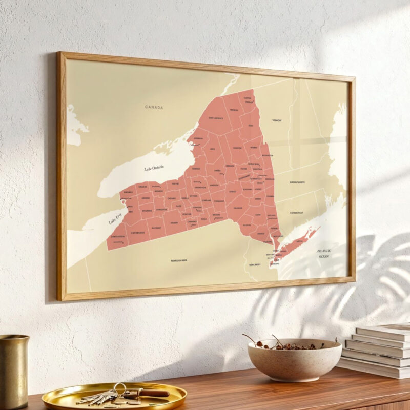 Framed New York county map hanging on a textured wall, styled with warm natural lighting.