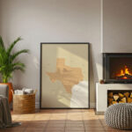A framed Texas map positioned on the floor near a glowing fireplace, adding a warm decorative touch to a relaxed living room space.