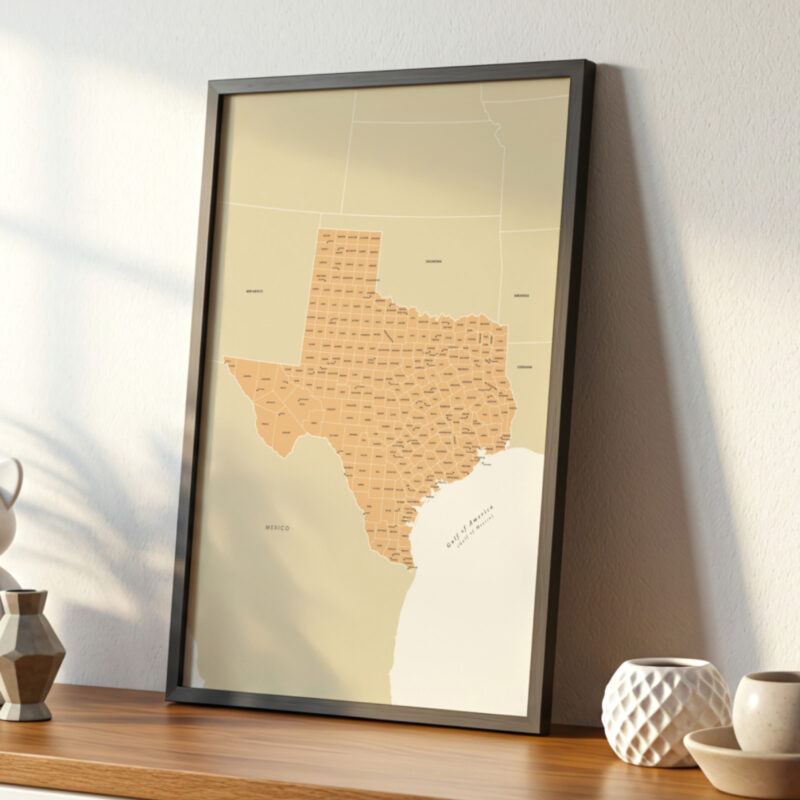 A close-up look at a framed Texas state map displayed on a wooden surface, illuminated by soft sunshine and complemented by simple decorative pieces.