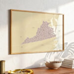 Virginia state map print mounted above a wooden console table, shown in soft daylight with decorative objects arranged below.