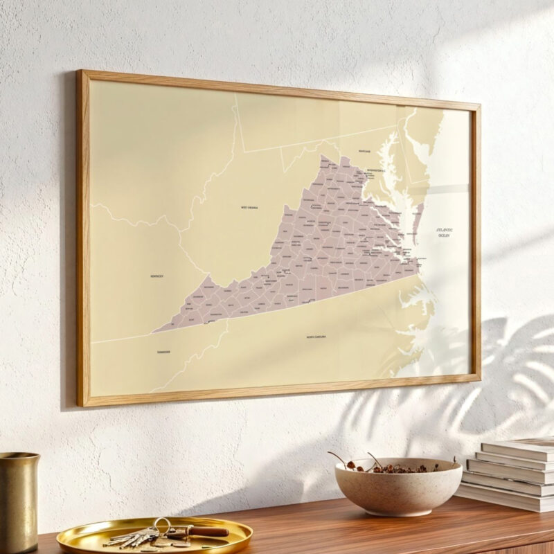 Virginia state map print mounted above a wooden console table, shown in soft daylight with decorative objects arranged below.