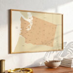 Washington state map print mounted above a wooden console table, illuminated by soft daylight with modern décor elements nearby.